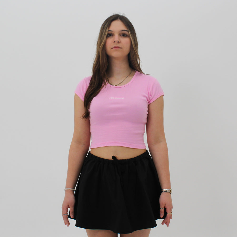 Pink baby tee with the “fuck la mode” script logo on the front — streetwear clothing from Québec City.