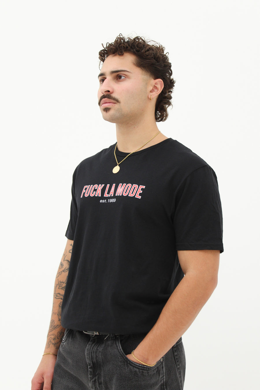 Black retro t-shirt with the red “fuck la mode” logo — streetwear clothing from Québec City.