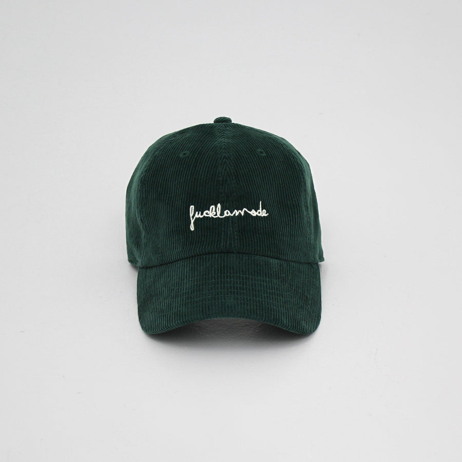 Green corduroy cap with the hand-written “fuck la mode” logo in white — streetwear clothing from Québec City.