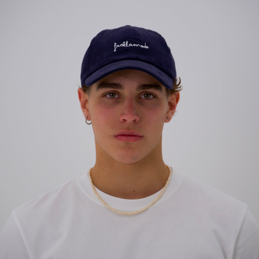 Navy corduroy cap with the “fuck la mode” script logo — streetwear clothing from Québec City.