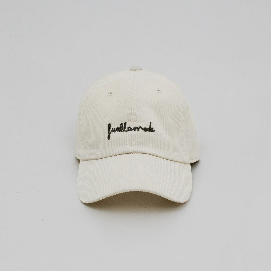 Off-white corduroy cap with the “fuck la mode” hand-written logo in black — streetwear clothing from Québec City.