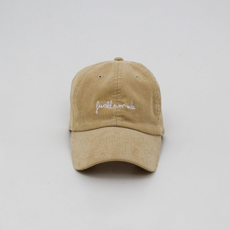 Sand corduroy cap with the “fuck la mode” hand-written logo in black — streetwear clothing from Québec City.