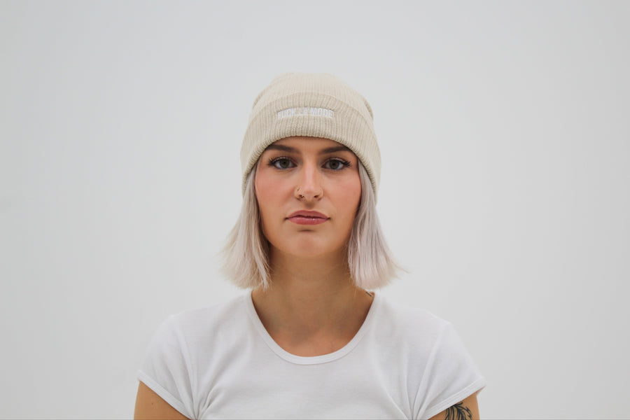 Cream cotton beanie with the embroidered “fuck la mode” logo in white — streetwear clothing from Québec City.