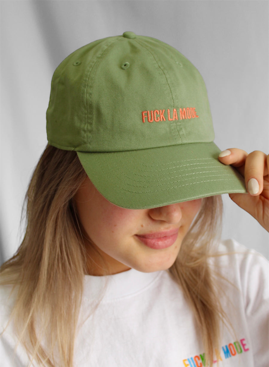 Pistachio cotton stone-washed cap with the “fuck la mode” logo in orange — streetwear clothing from Québec City.