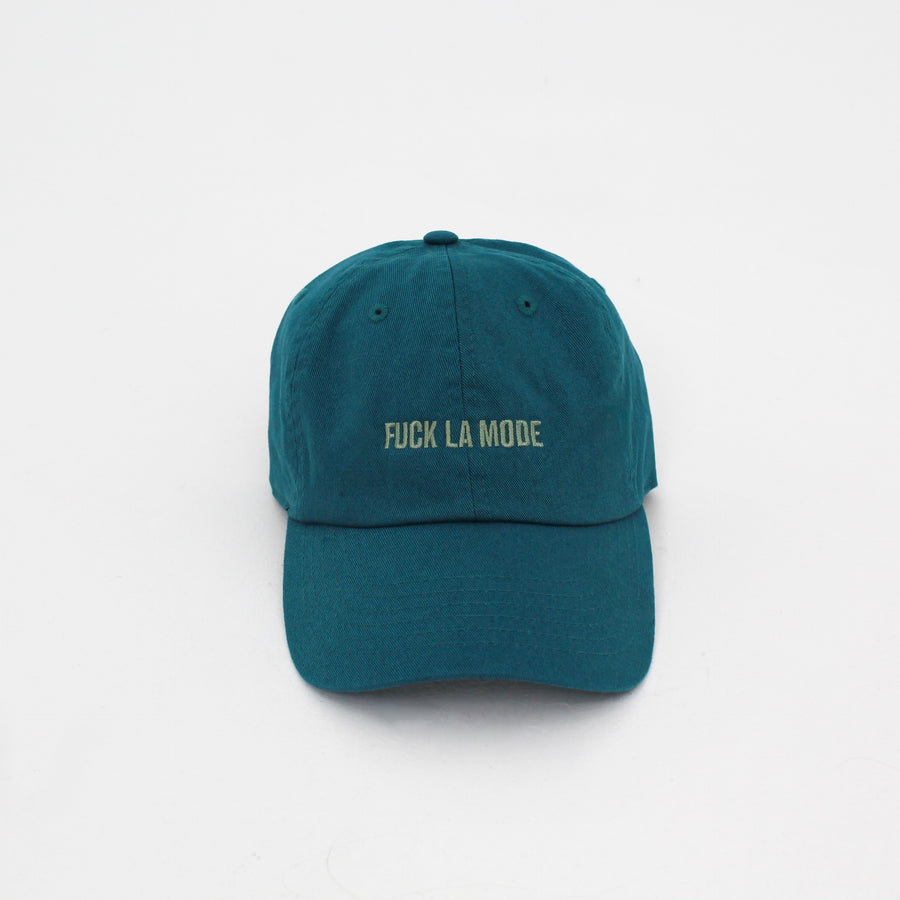 Teal cotton stone-washed cap with the “fuck la mode” logo in green — streetwear clothing from Québec City.