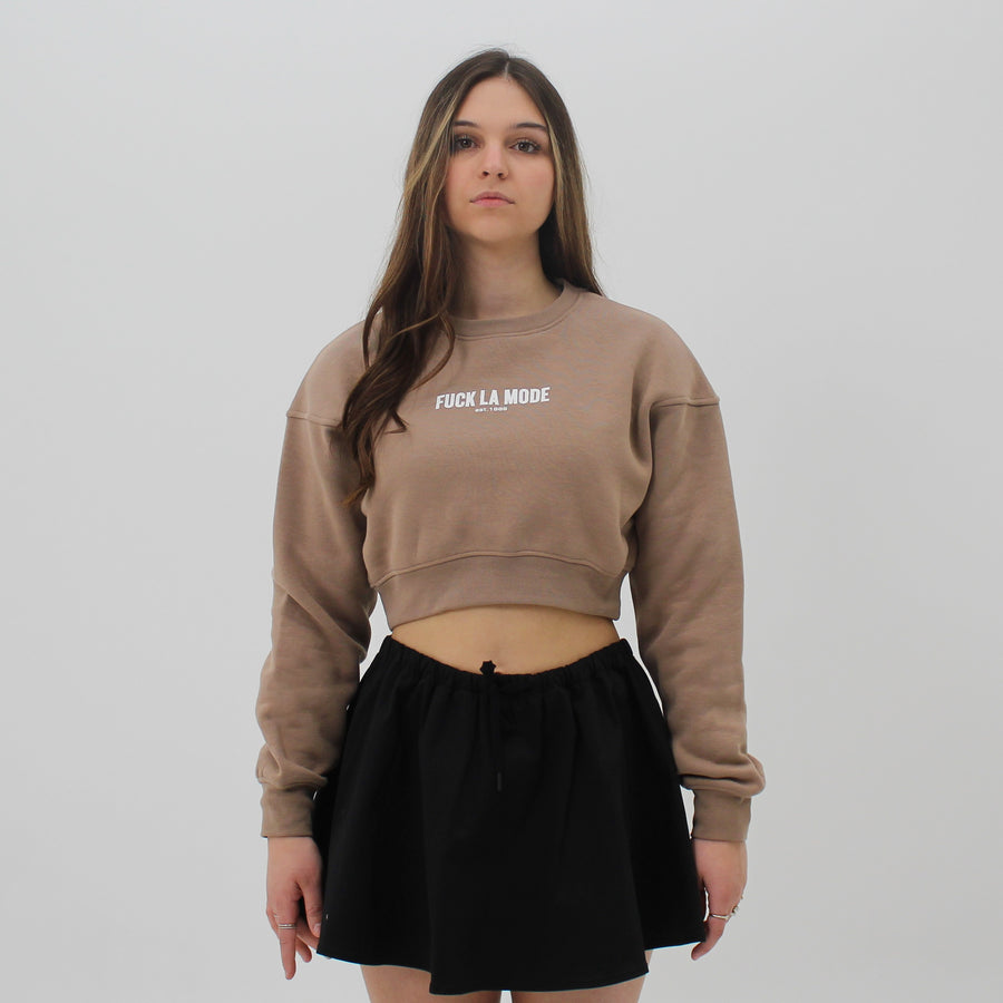Toast cropped sweater with the “fuck la mode” logo in white at the center of the chest — streetwear clothing from Québec City.
