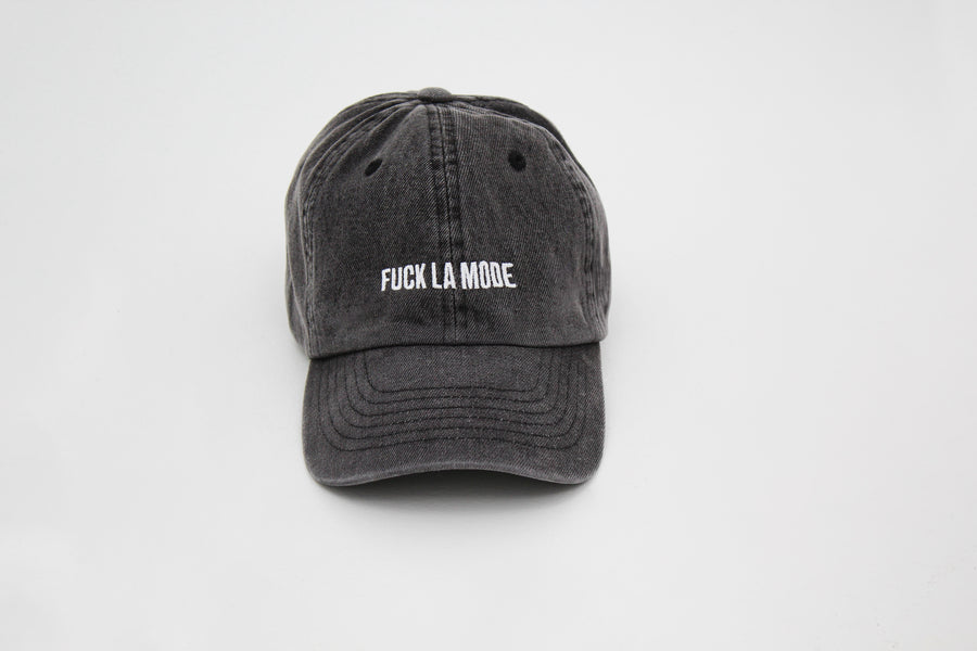 Black denim cap with the embroidered “fuck la mode” logo in white — streetwear clothing from Québec City.