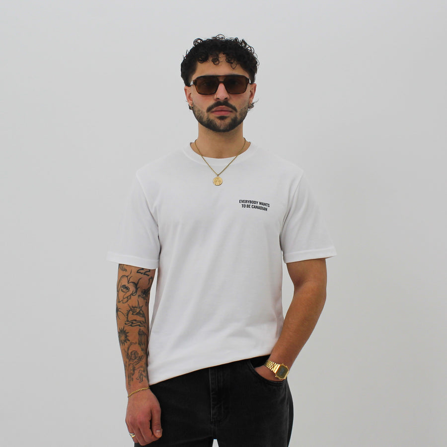 White shirt with “Everybody Wants To Be Canadian” and a red maple leaf “fuck la mode” — streetwear clothing from Québec City.