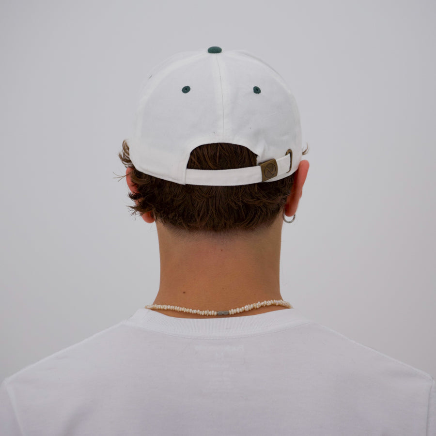 Green and white “fuck la mode” script cap — streetwear clothing from Québec City.