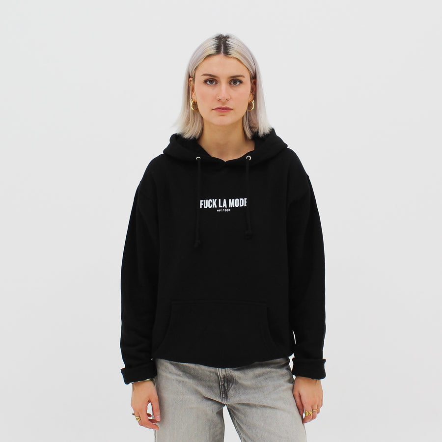 Black heavyweight classic hoodie with the “fuck la mode” logo in white — streetwear clothing from Québec City.