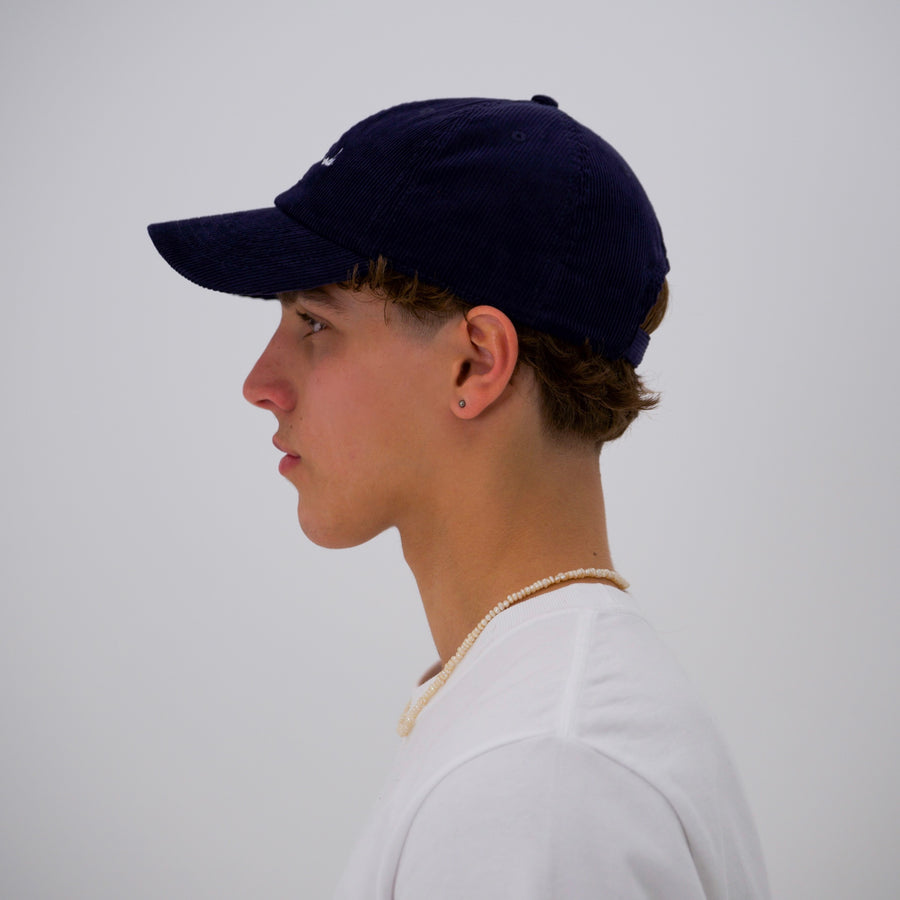 Navy corduroy cap with the “fuck la mode” script logo — streetwear clothing from Québec City.