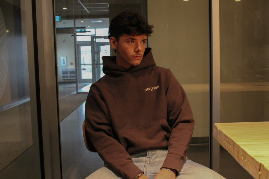Oversized brown address hoodie with cream lettering — streetwear clothing from Québec City.