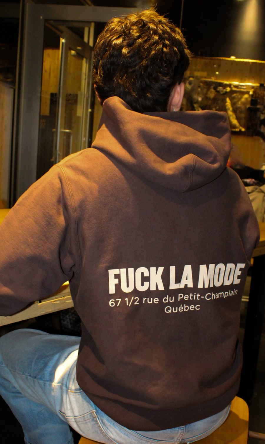 Oversized brown address hoodie with cream lettering — streetwear clothing from Québec City.
