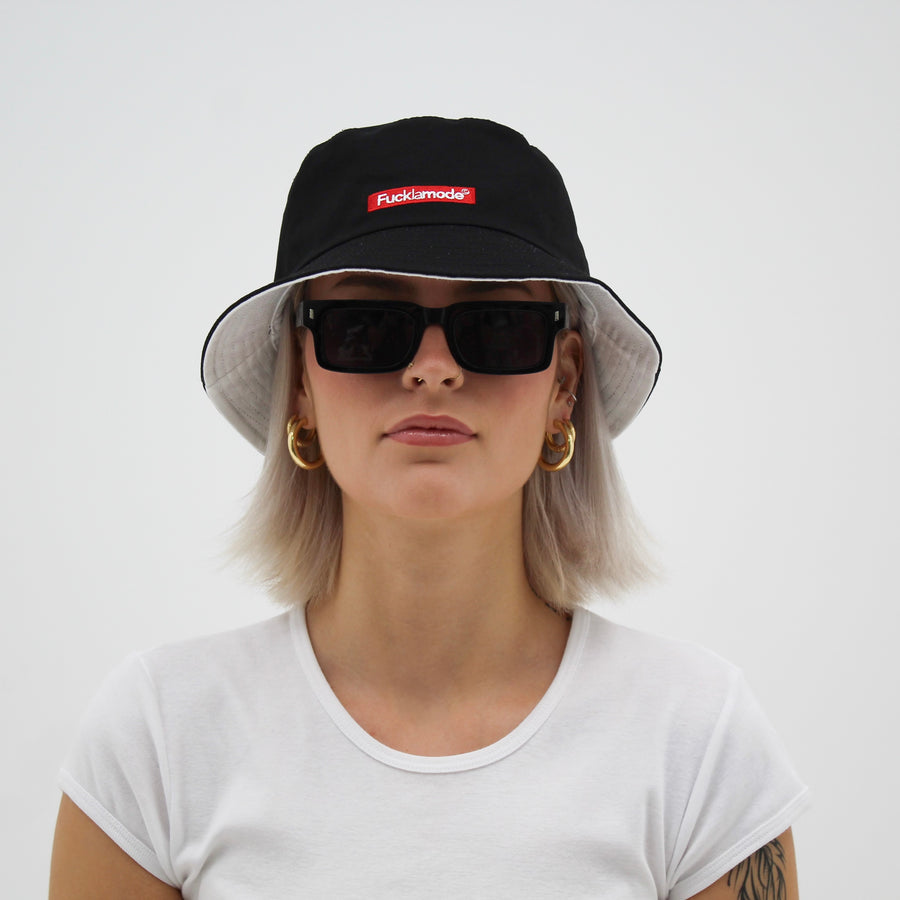Reversible white and black bucket hat with the “fuck la mode” logo — streetwear clothing from Québec City.
