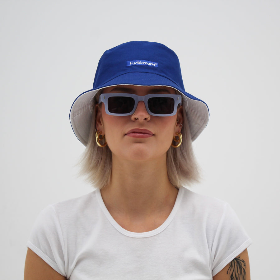 Reversible white and blue bucket hat with the “fuck la mode” logo — streetwear clothing from Québec City.