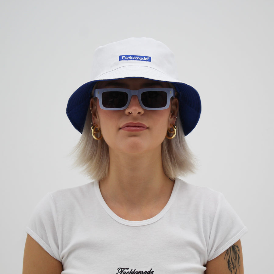 Reversible white and blue bucket hat with the “fuck la mode” logo — streetwear clothing from Québec City.