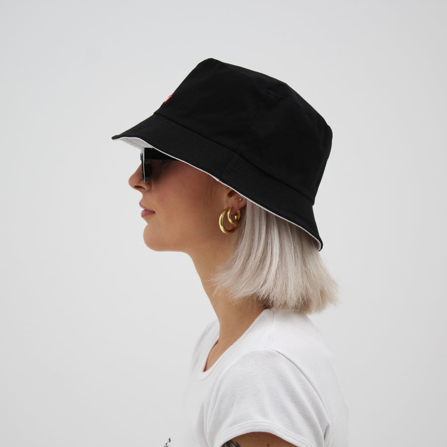 Reversible white and black bucket hat with the “fuck la mode” logo — streetwear clothing from Québec City.