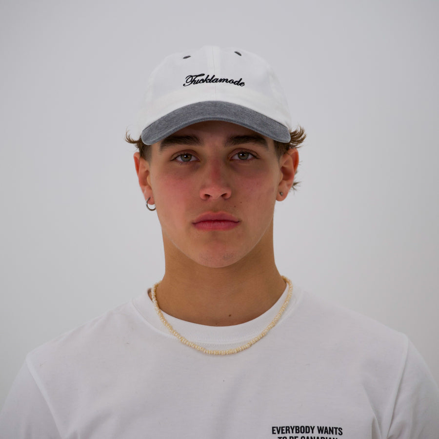 Black and white “fuck la mode” script cap — streetwear clothing from Québec City.