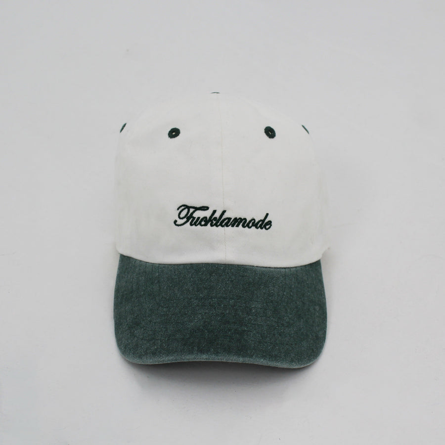 Green and white “fuck la mode” script cap — streetwear clothing from Québec City.
