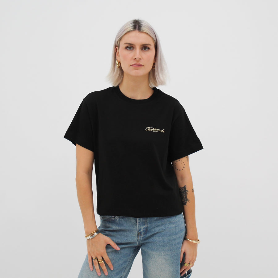 Black “fuck la mode” script t-shirt with the “fuck la mode” script logo — streetwear clothing from Québec City.