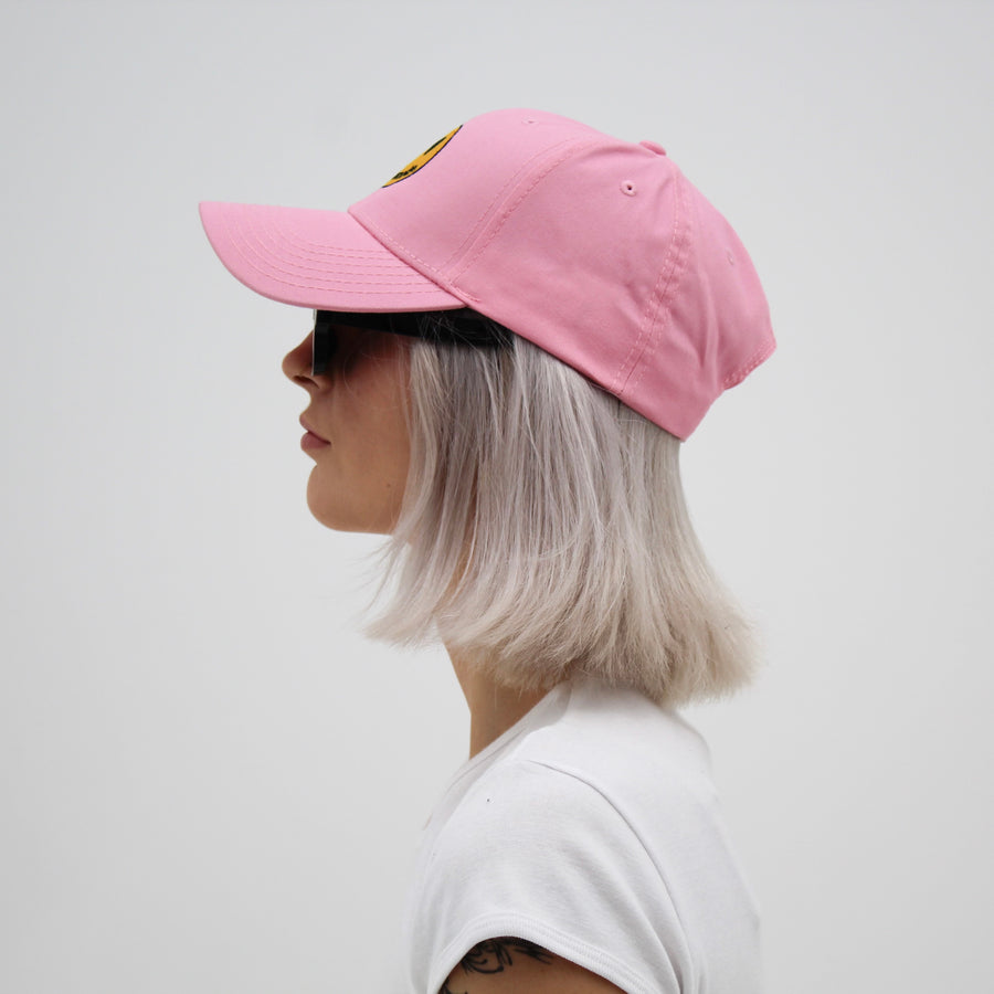 Pink trucker hat with a yellow smiley face “fuck la mode” — streetwear clothing from Québec City.