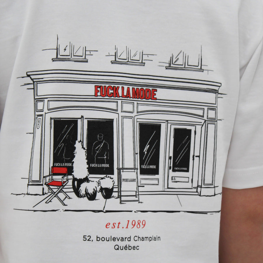 White t-shirt with black front store illustration and red “fuck la mode” logo — streetwear clothing from Québec City.