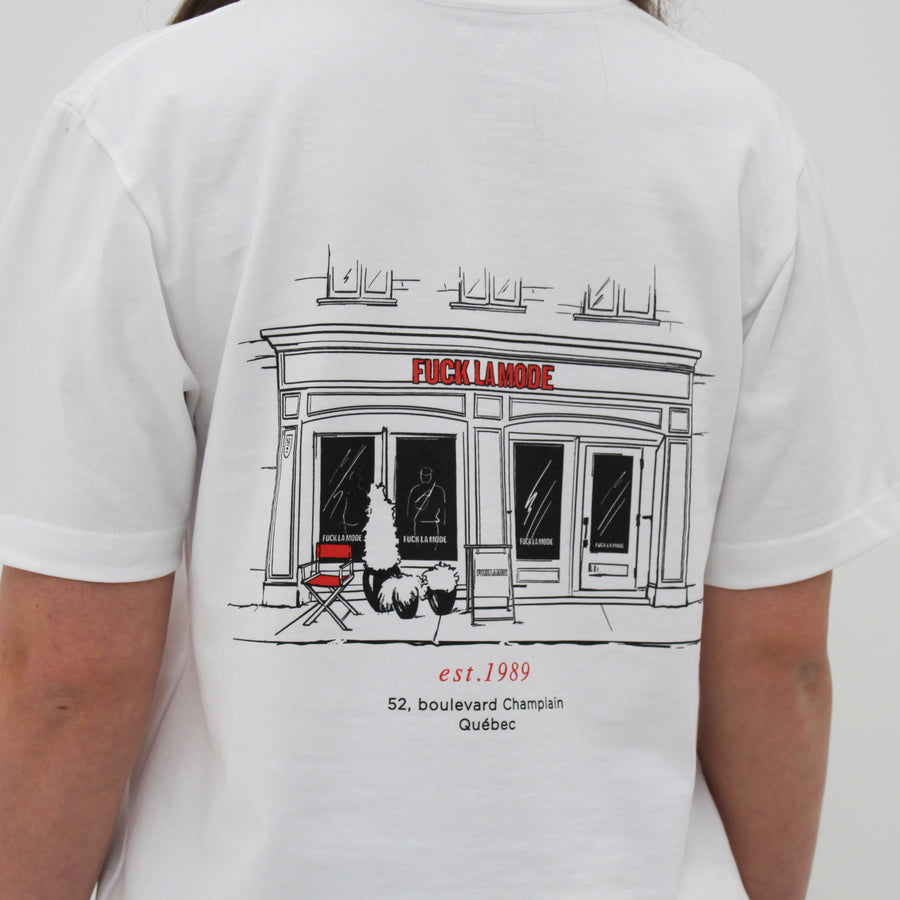 White t-shirt with black front store illustration and red “fuck la mode” logo — streetwear clothing from Québec City.