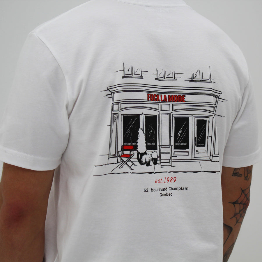 White t-shirt with black front store illustration and red “fuck la mode” logo — streetwear clothing from Québec City.