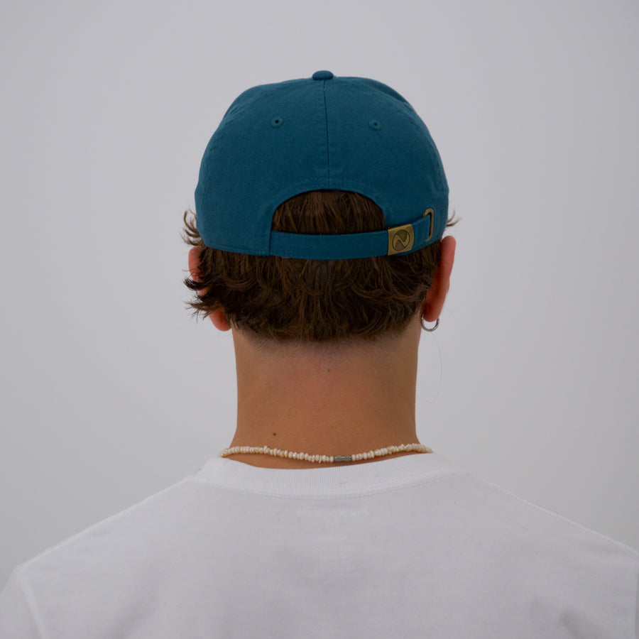 Teal cotton stone-washed cap with the “fuck la mode” logo in green — streetwear clothing from Québec City.