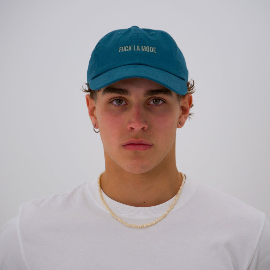 Teal cotton stone-washed cap with the “fuck la mode” logo in green — streetwear clothing from Québec City.
