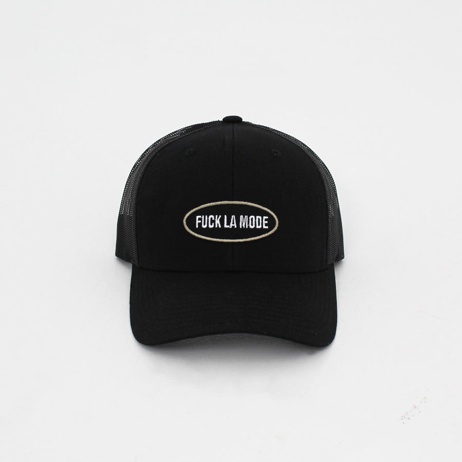 Black trucker “fuck la mode” cap with a “fuck la mode” logo patch on the front — streetwear clothing from Québec City.