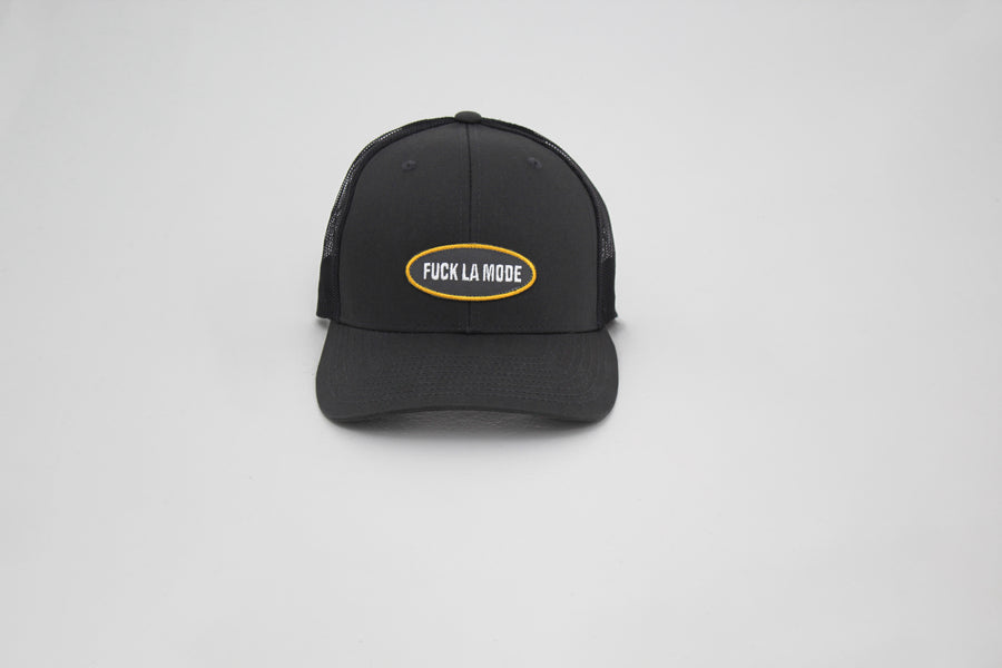 Charcoal trucker “fuck la mode” cap with a “fuck la mode” logo patch on the front — streetwear clothing from Québec City.