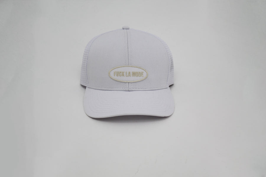 White trucker “fuck la mode” cap with a white patched logo — streetwear clothing from Québec City.