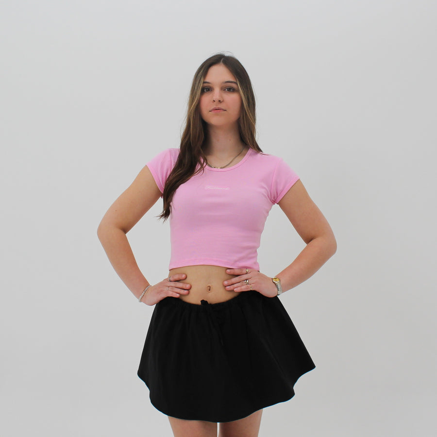 Pink baby tee with the “fuck la mode” script logo on the front — streetwear clothing from Québec City.
