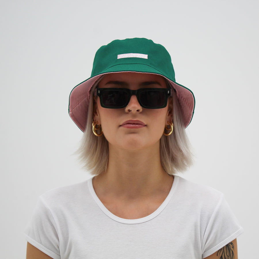 Reversible green and pink bucket hat with the “fuck la mode” logo — streetwear clothing from Québec City.