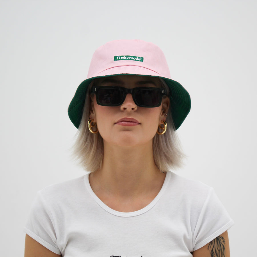 Reversible green and pink bucket hat with the “fuck la mode” logo — streetwear clothing from Québec City.