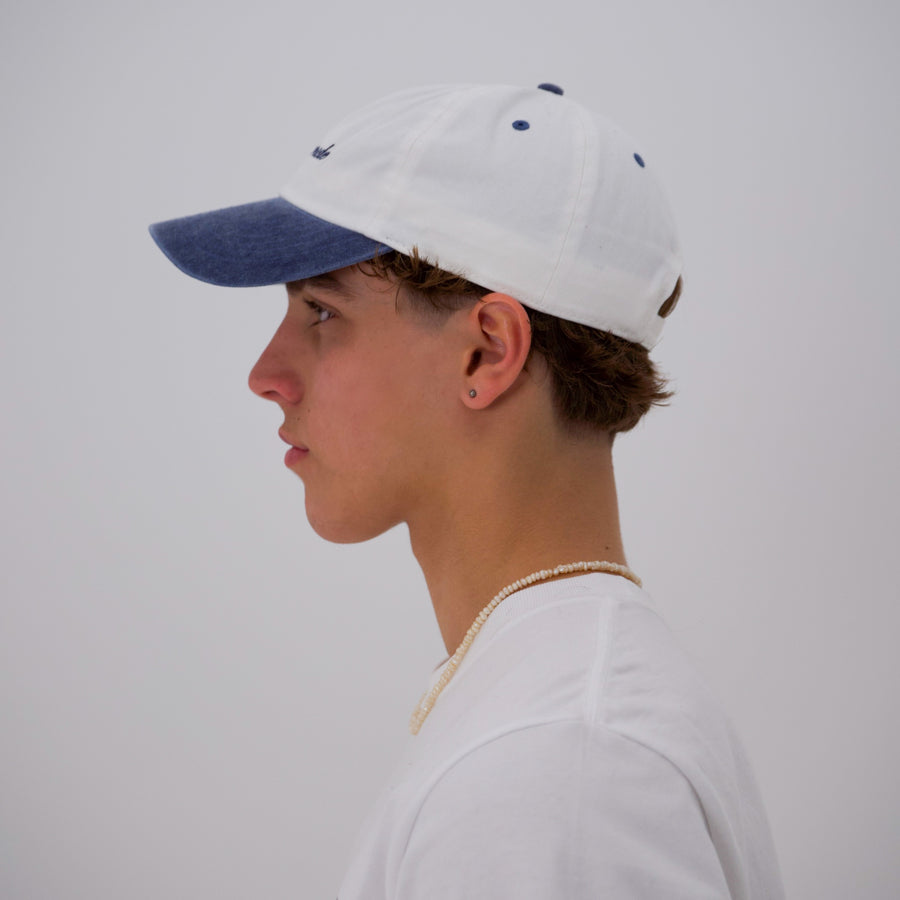 Blue and white “fuck la mode” script cap — streetwear clothing from Québec City.