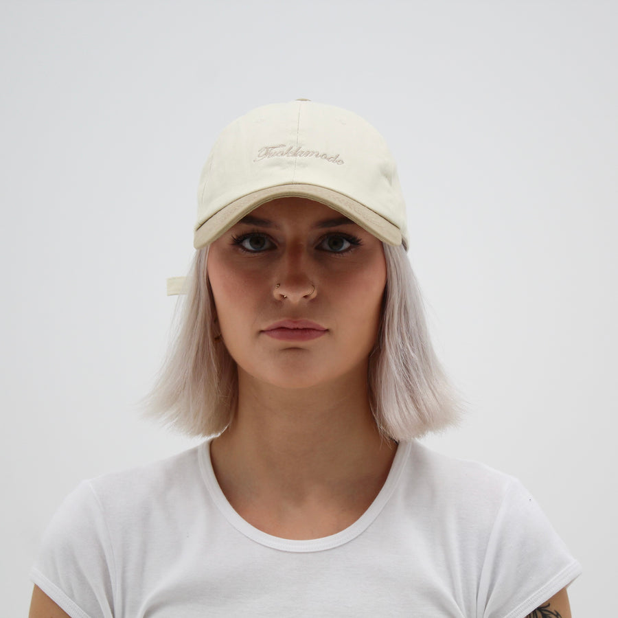 Beige cap with the ““fuck la mode”” script — streetwear clothing from Québec City.