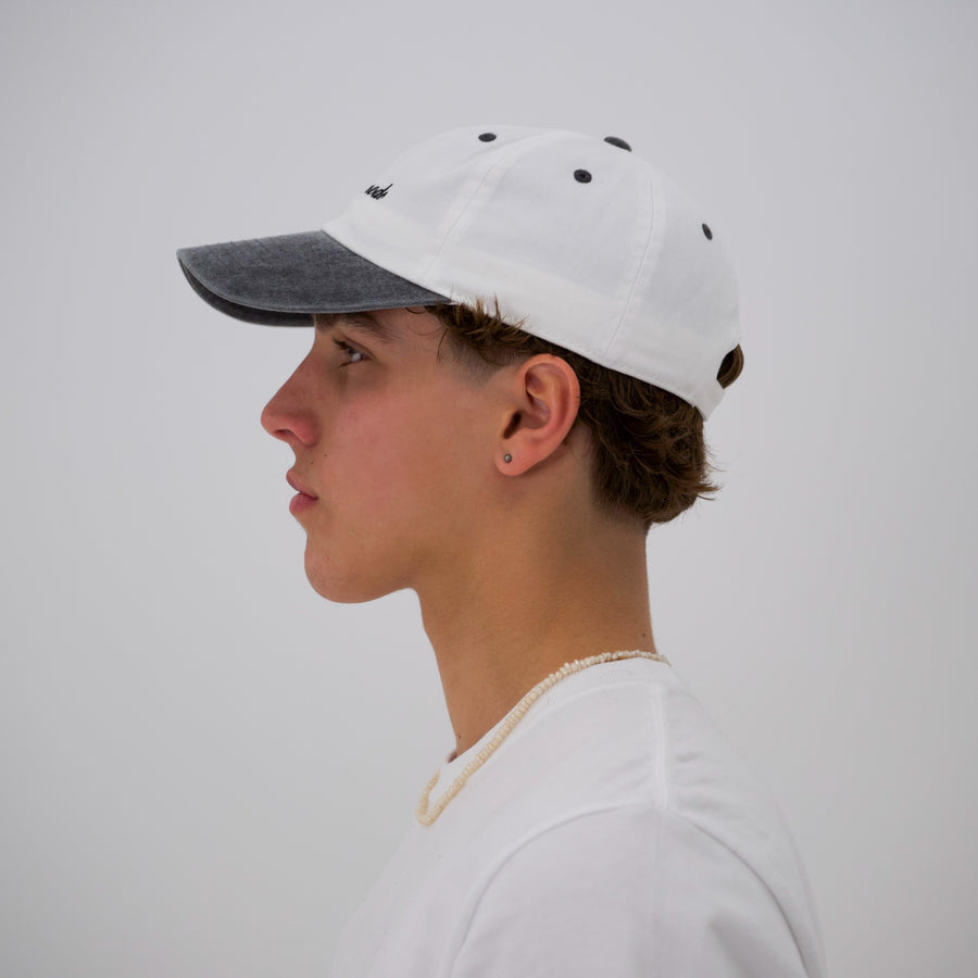 Black and white “fuck la mode” script cap — streetwear clothing from Québec City.