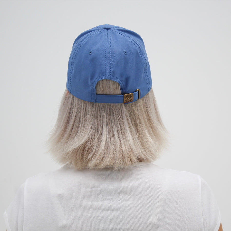 Blue trucker hat with a yellow smiley face “fuck la mode” — streetwear clothing from Québec City.