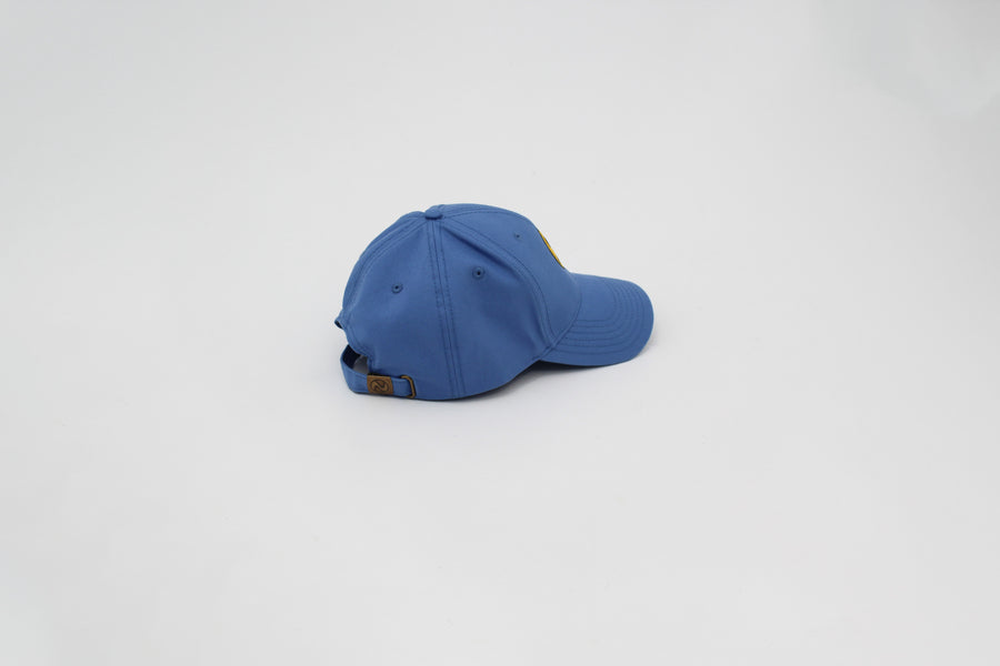 Blue trucker hat with a yellow smiley face “fuck la mode” — streetwear clothing from Québec City.