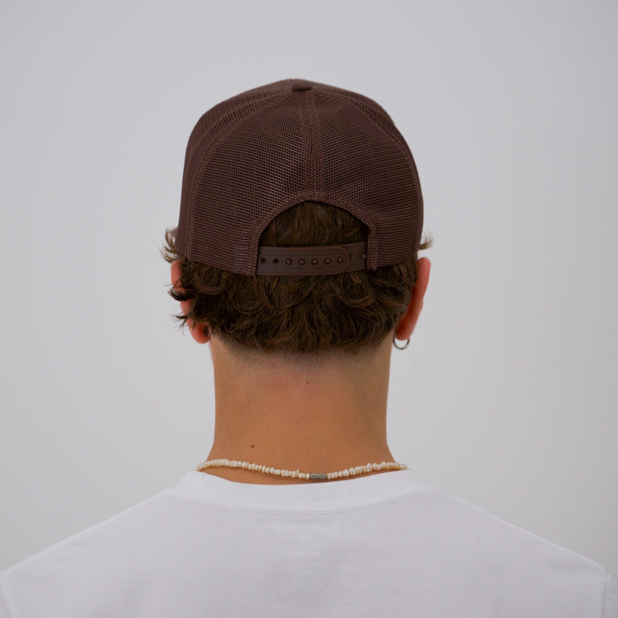 Brown teddy bear style trucker cap with the “fuck la mode” logo in cream — streetwear clothing from Québec City.