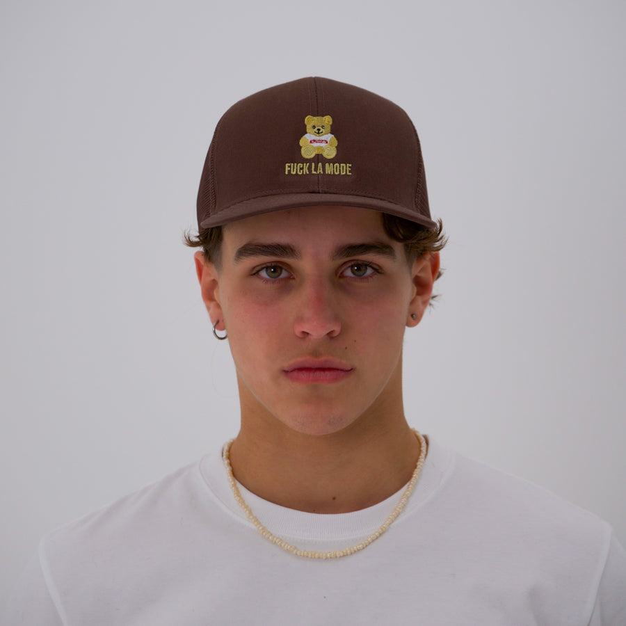 Brown teddy bear style trucker cap with the “fuck la mode” logo in cream — streetwear clothing from Québec City.