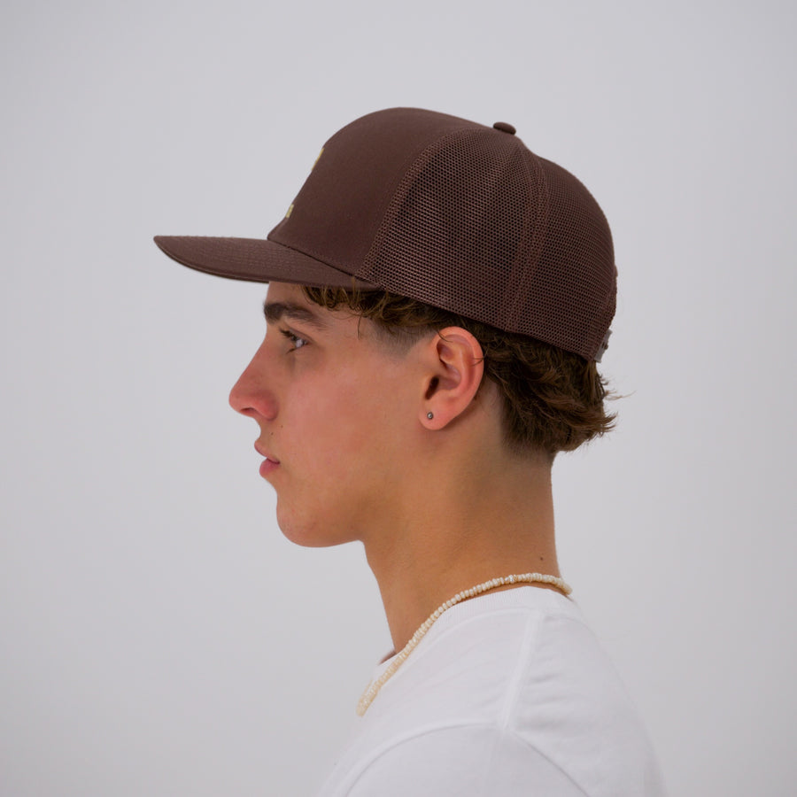 Brown teddy bear style trucker cap with the “fuck la mode” logo in cream — streetwear clothing from Québec City.