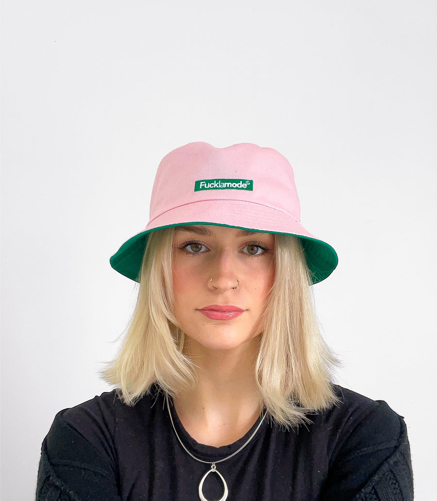 Reversible green and pink bucket hat with the “fuck la mode” logo — streetwear clothing from Québec City.