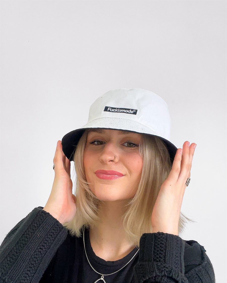 Reversible white and black bucket hat with the “fuck la mode” logo — streetwear clothing from Québec City.
