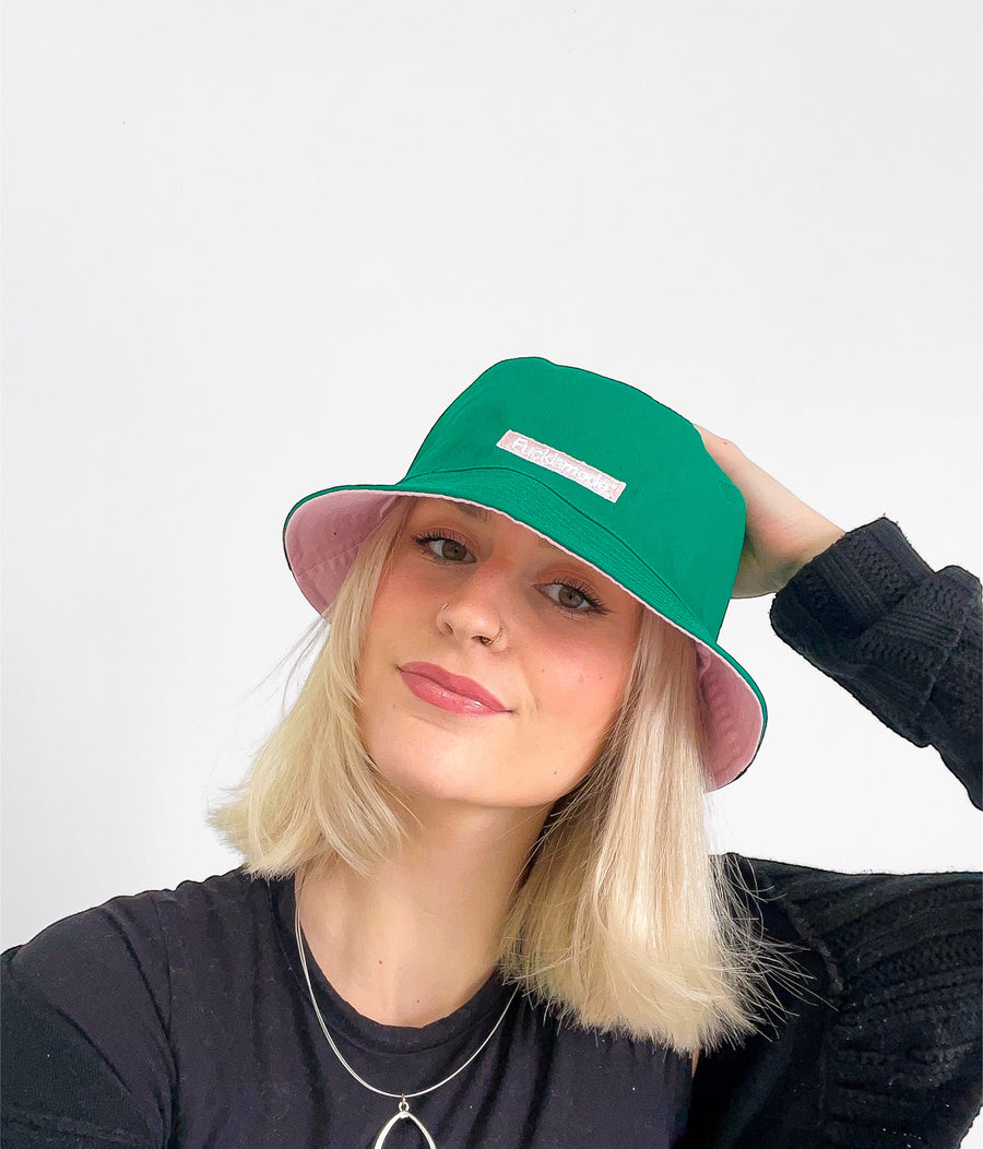 Reversible green and pink bucket hat with the “fuck la mode” logo — streetwear clothing from Québec City.