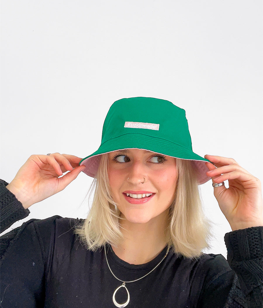 Reversible green and pink bucket hat with the “fuck la mode” logo — streetwear clothing from Québec City.